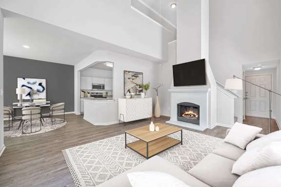 A modern living room with a fireplace and a dining table at Reserve at Canyon Creek,Texas