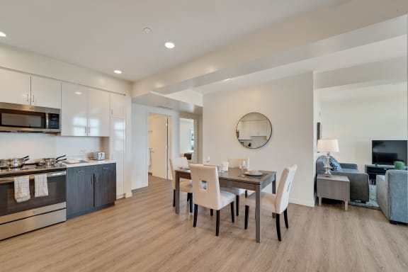 a dining room with a table and chairs and a kitchen