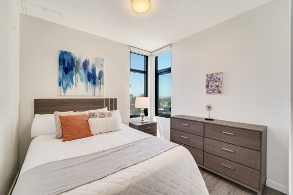 a bedroom with a bed and a large window