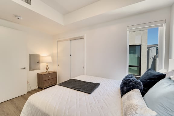 a bedroom with a large bed and a window