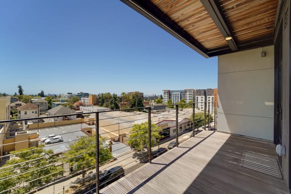 a view of a city from a balcony with a balcony fence
