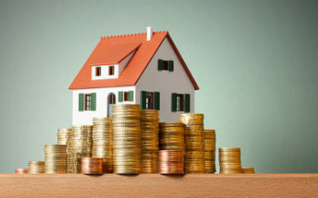 a house sitting on top of a stack of coins