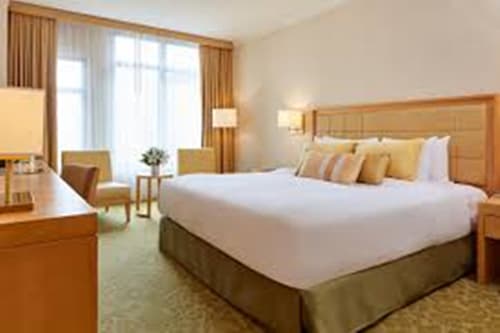 a hotel room with a large bed and a desk