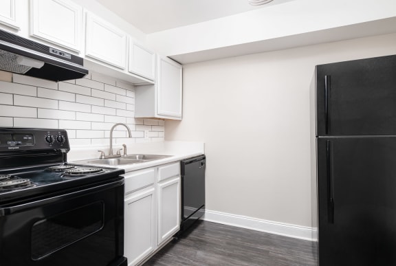 Kitchen with White Cabinets at Elite at Lakeview in College Park, GA