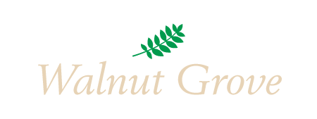 A logo with a leaf and the words &quot;Walnut Grove&quot; written in white.