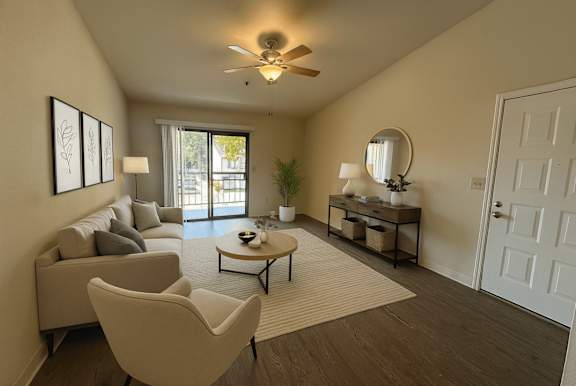 A living room with a couch, chairs, and a coffee table.