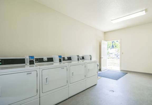 A row of washing machines in a laundromat.