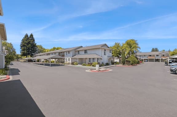 A sunny day at a residential complex with a clear blue sky.