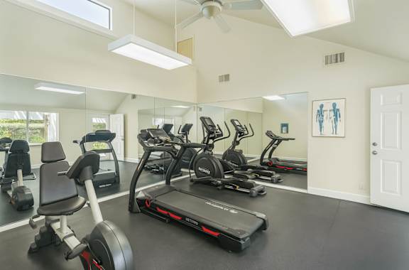 A spacious home gym with a variety of exercise equipment.