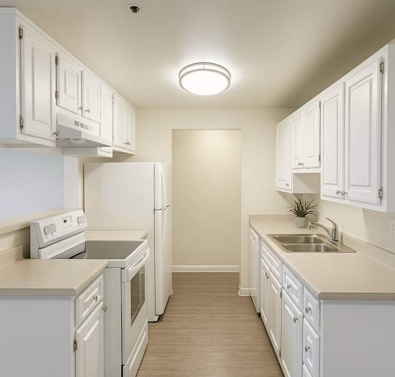 A kitchen with white cabinets and appliances.