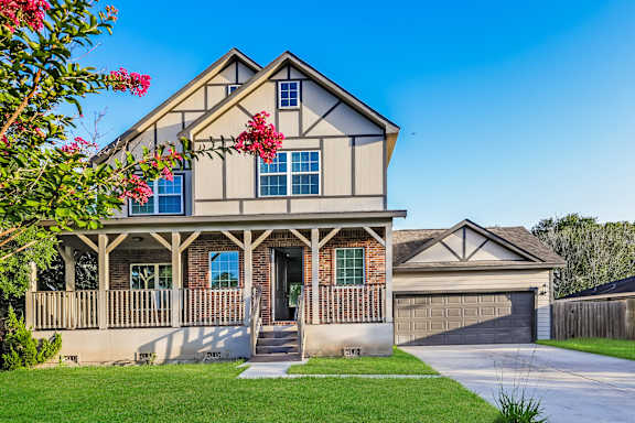 A house with a front porch and a garage.