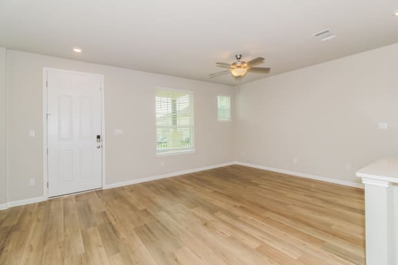 a bedroom with hardwood floors and a ceiling fan