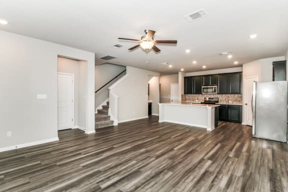 the living room and kitchen in a bedroom plus den unit.