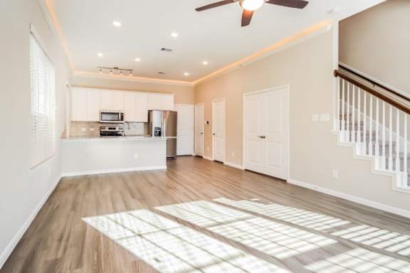 A sunny day with a kitchen and living room in a house.