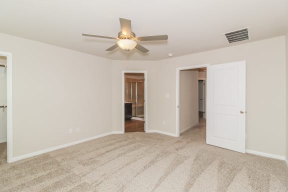 a bedroom with a ceiling fan