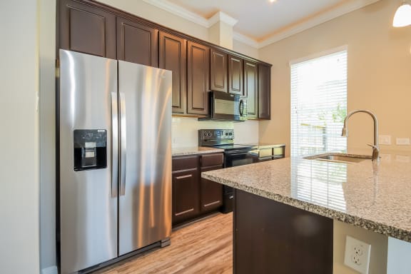 Island Kitchen with Appliances and Granite Countertops