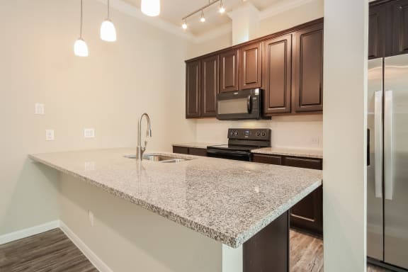 Island Kitchen with Appliances and Granite Countertops