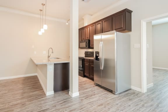 Island Kitchen with Appliances and Granite Countertops