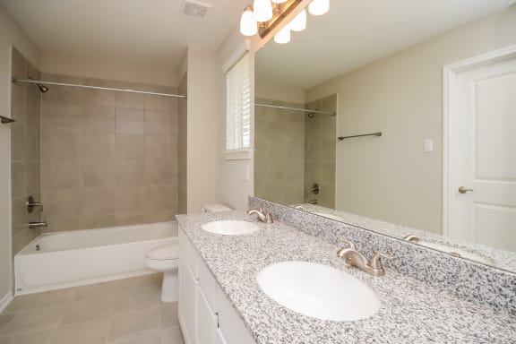 Renovated Bathrooms With Quartz Counters at Pradera Oaks, Bonney, TX, 77583