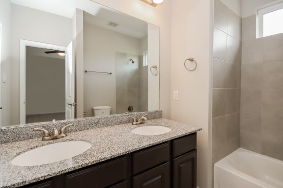 Bathroom with Granite Countertops and Double Vanity