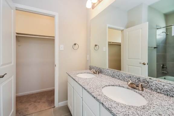 A bathroom with a sink and mirror.