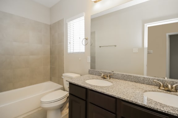 Bathroom with Granite Countertops and Double Vanity