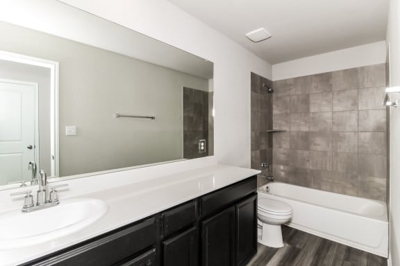 a bathroom with a toilet sink and bathtub