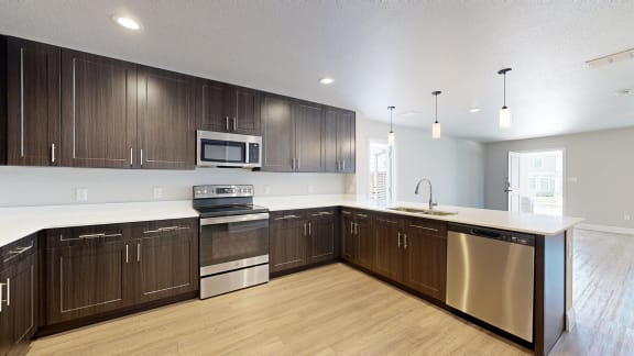 a large kitchen with wooden cabinets and stainless steel appliances