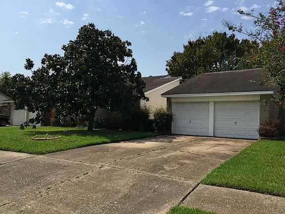 A residential house with a driveway and garage.