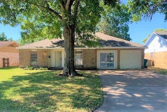 A house with a tree in front of it.