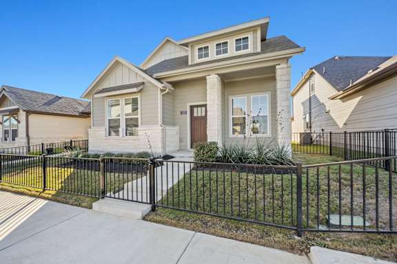 A house with a black fence in front of it.