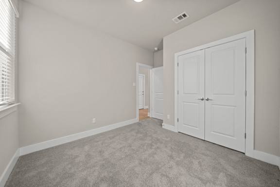 A room with a carpeted floor and white walls.