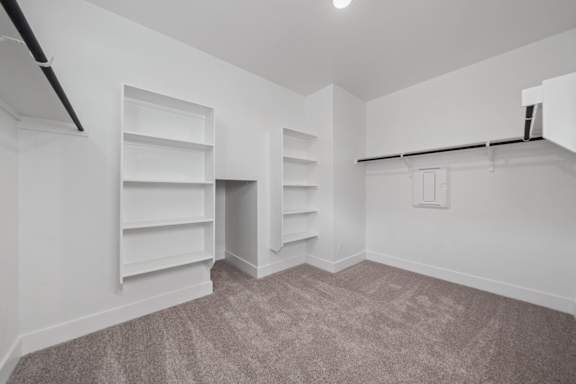 A room with a carpeted floor and white walls.