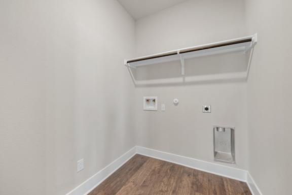 A white wall with a shelf and a light switch.