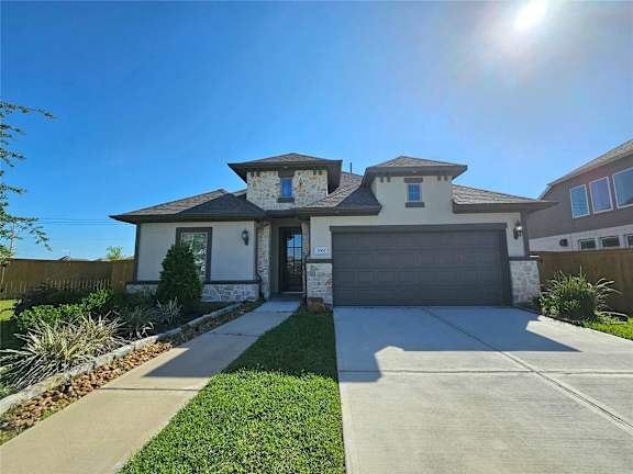 A house with a garage and a driveway.