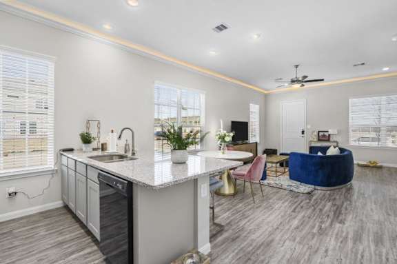 A modern kitchen with a dining area and a living room.