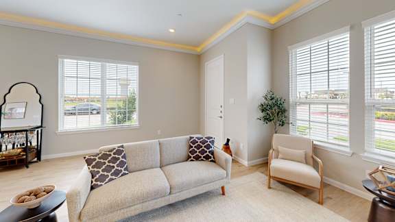 a living room with a couch and two chairs