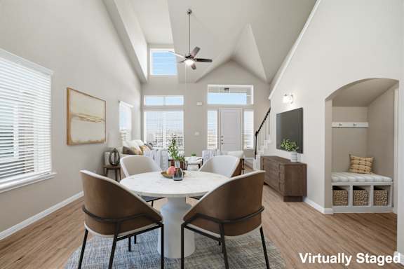 A dining room with a table and chairs.