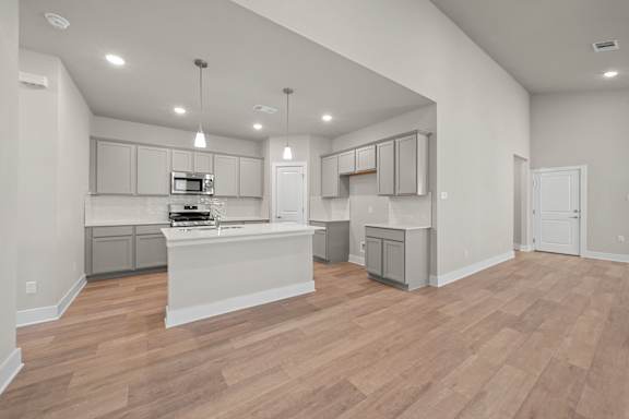 A kitchen with wooden floors and white walls.