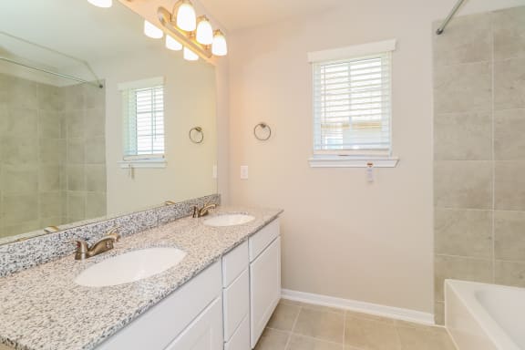 a bathroom with two sinks and a mirror