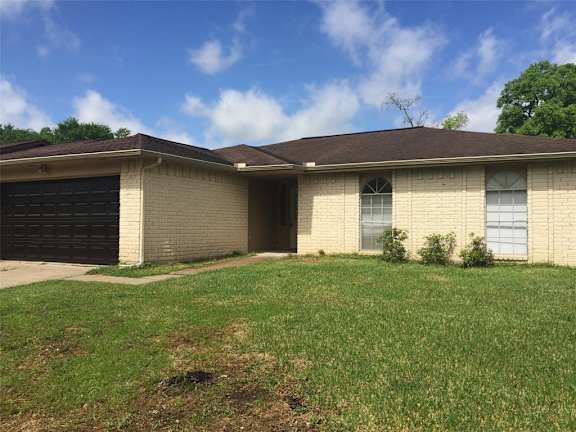 A house with a brown roof and a garage door.
