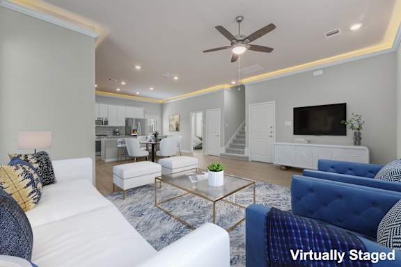 A living room with a white couch and a blue couch.