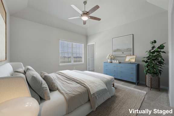 A bedroom with a bed, a dresser, and a ceiling fan.