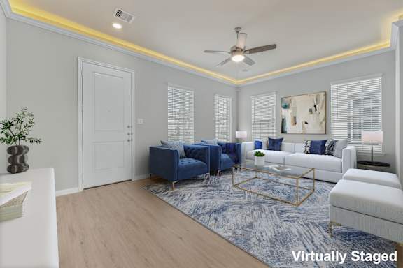 A living room with a blue couch and a white couch.