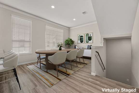 A dining room with a table and chairs.
