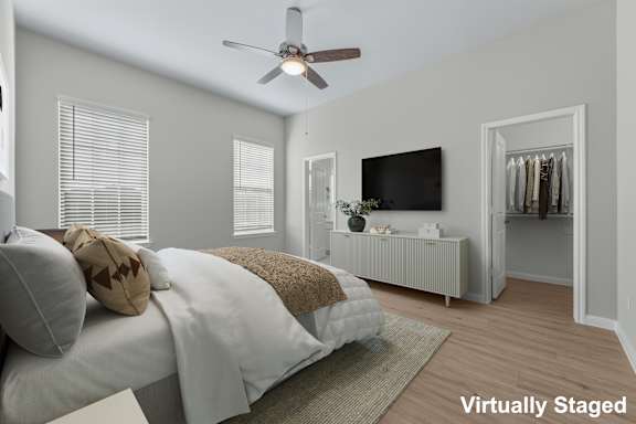 A bedroom with a bed, a television, and a wardrobe.