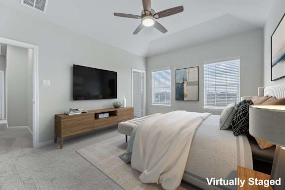 A bedroom with a bed, a dresser, a ceiling fan, and a television.