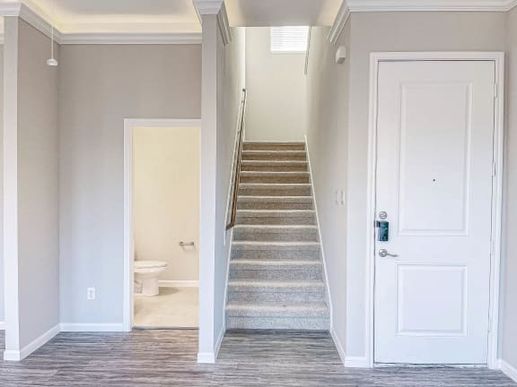 a view of the stairs in a home with a white door