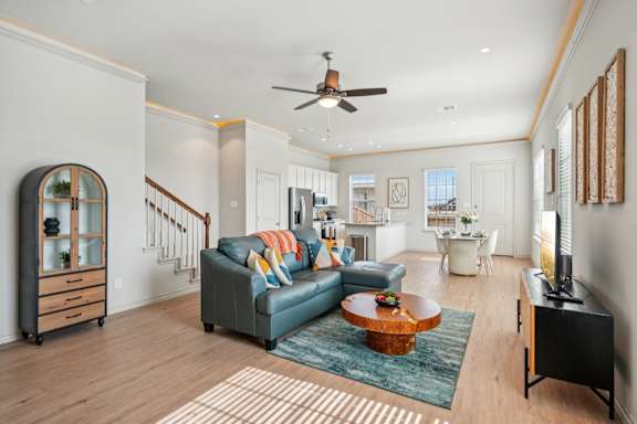 A living room with a blue couch and a wooden coffee table.