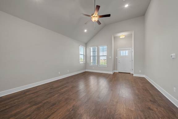 A room with wooden floors and a ceiling fan.